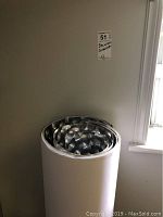Rolled metallic decorative covering panels stacked together