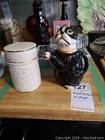 Shows Royal Doulton white dish and vintage dog teapot from first angle