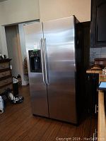 Front view of stainless steel side-by-side refrigerator freezer