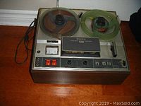 Full view of the Sony reel to reel tape recorder showing two reels, control panel, and wood case