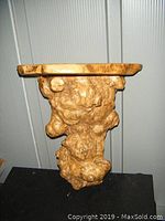 Side view of solid wood burl shelf showing textured bulbous burl knots and flat shelf surface