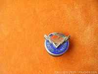 Front view of the small round pin showing the blue background with 'RADIO CANADA' text and central 'CBC' logo with a V-shaped wing design.