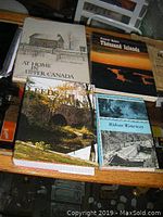 Image showing all four books stacked including 'At Home in Upper Canada', 'Thousand Islands', 'Leeds and Lansdowne', and 'Rideau Waterway'.