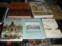Six local history books about Kingston and Denbigh, arranged on a surface showing titles and cover art.