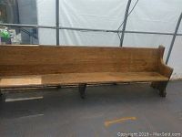 Full view of the entire 10 ft oak church pew showing the straight backrest and base structure.