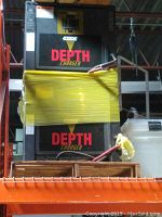 Photo showing two stacked Exide Gold Depth battery chargers wrapped in yellow plastic, with visible power cables and branding.