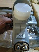 Close-up photo of a single dual LNB unit showing label and design details indicating use with Dish digital satellite system.