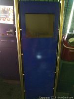 Front view of the tall blue kiosk featuring an integrated touchscreen monitor on the upper half and blank lower panels.