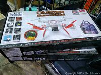 Photo of two boxed Omega Spy Drones stacked together, showing packaging details and branding.