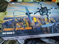 Photo of Riviera Night Stalker drone box with nighttime cityscape background and drone image on front.