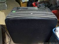 Closed black hard plastic suitcase containing photo ID processing equipment