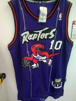 Front view of Toronto Raptors basketball jersey with prominent dinosaur logo and number 10.