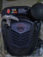 Top view of black plastic shroud with 140cc OHV label and pull start handle.