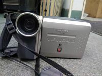 Sharp VL E760 Viewcam front showing lens and camera strap