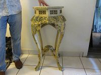 Front perspective showing full stand height and intricate carvings on legs and apron.