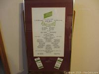 Full framed display showing the playbill with two admission tickets.