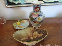 Full view showing Nippon vase, Noritake lemon dish, and hand-painted bowl on wood surface