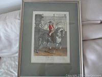 Full view of framed large European soldier engraving/etching print showing soldier on horse with architectural background.