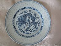 Top-down view showing hand-painted blue dragon and translucent cut-out patterned border.