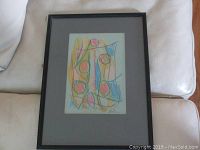 Full view of framed crayon drawing artwork showing abstract color shapes and lines.