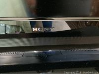 Close-up photo of the Sony logo on the TV frame.