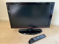 Front view of the 21 inch Samsung flat screen TV with remote control placed in front.