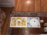 Top view showing Beatrix Potter storybooks and nursery tea set in its original packaging on a wooden table