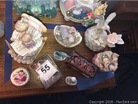 Overview photo of all ceramic figurines, music box, and decorative boxes on a table