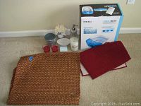 Homedics foot spa box with bath and home decor items including candles, bath mats, and soap