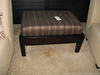 Upholstered bench with striped fabric seat and dark wood frame