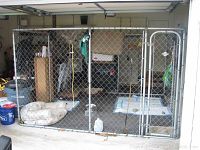 Full front view of assembled kennel inside garage