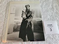 Full view of the 8x10 black and white autographed photo of Christopher Lambert standing holding a sword in a trench coat.