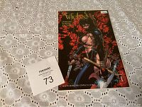 Photo showing The Wicked comic book with sealed plastic and certificate of authenticity numbered 73.