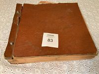 Worn brown cover of the vintage record book, showing extensive wear and stripped binding.