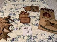 Photo showing the magnets, tin stars, blank books, tin hook, ornament, and part of the quilt background