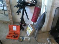 Overview of Mercury motor, flare gun case, flares, boxes and storage tubes