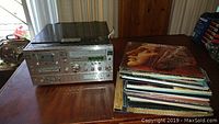 Front view of Yorx stereo system with cassette and 8-track players and stacks of vinyl records beside it