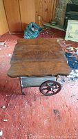Full top view of closed wooden tea caddy on carpeted floor with carved leg details visible.