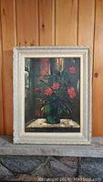 Framed painting showing full view of rose bouquet artwork, wooden paneled background.
