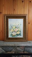 Full view of the framed floral painting showing the entire artwork and frame