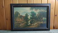 Full view of framed vintage village landscape painting on board.