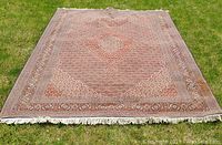 Full view of rug laid flat on grass