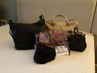 Four handbags in assorted styles and colors including Michael Kors, Oryany, Aimee Kestenberg, and a small black beaded bag.