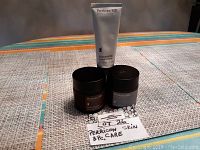 Three Perricone MD skin care products displayed on a table with a handwritten note.