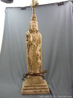 Full view of the plaster Buddha-shaped lamp approximately 24 inches tall with electrical cord and lamp socket visible.