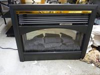 Front view of the electric fireplace showing black metal frame, faux logs, and glass panel.