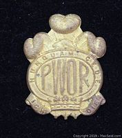 Front of vintage Canadian military cap badge showing crown, letters PWOR, and surrounding inscriptions.