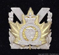 Front view of vintage Canadian military cap badge for The Perth Regiment showing detailed design and inscriptions.