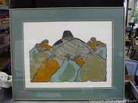 Framed print showing artwork with figures in blankets, detailed with earthy colors and black outlines.