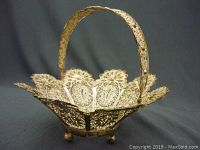 Front view of the vintage candy basket showing detailed filigree sides, scalloped edges, and round feet.